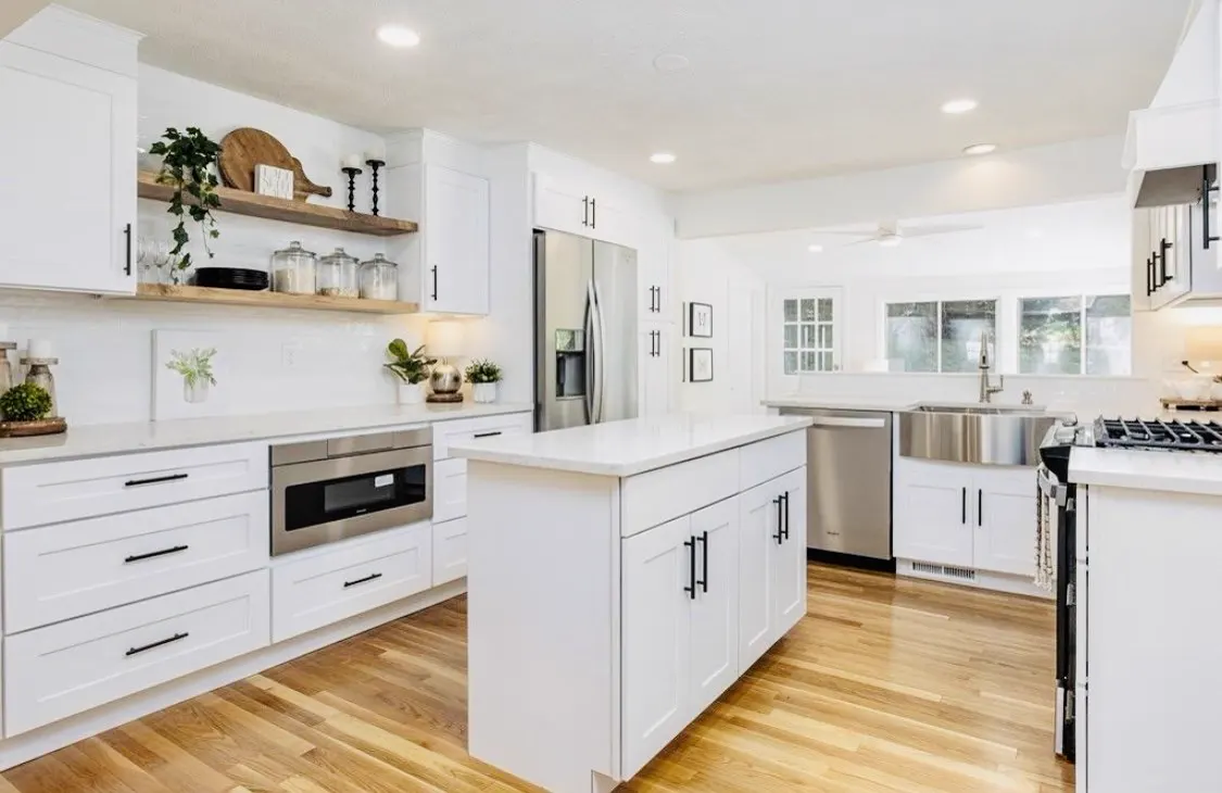 Bright white kitchen with quartz worktops and an island