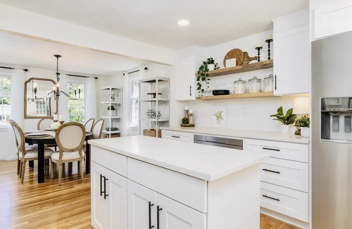 White quartz island in an open-plan kitchen and dining room