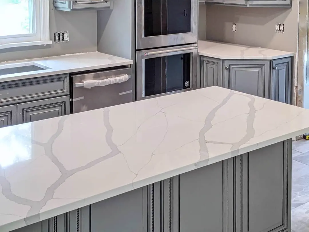Calacatta-style quartz worktop with grey cabinets
