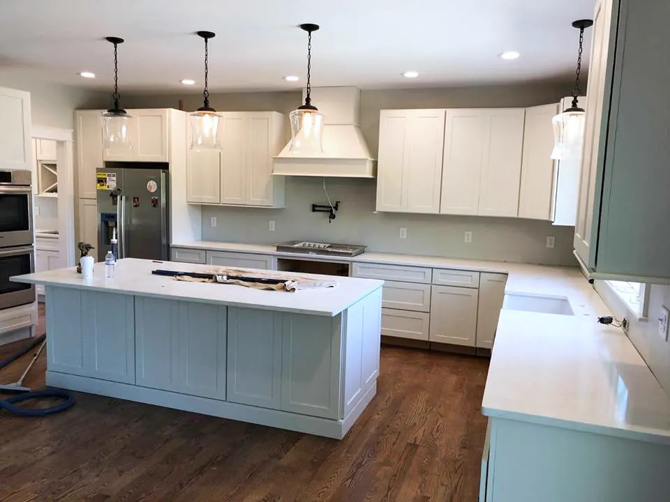 Kitchen island with a white quartz worktop and pendant lights