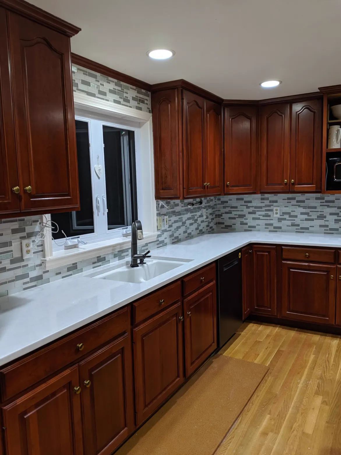 White quartz worktops with cherry wood cabinets, fitted by our team