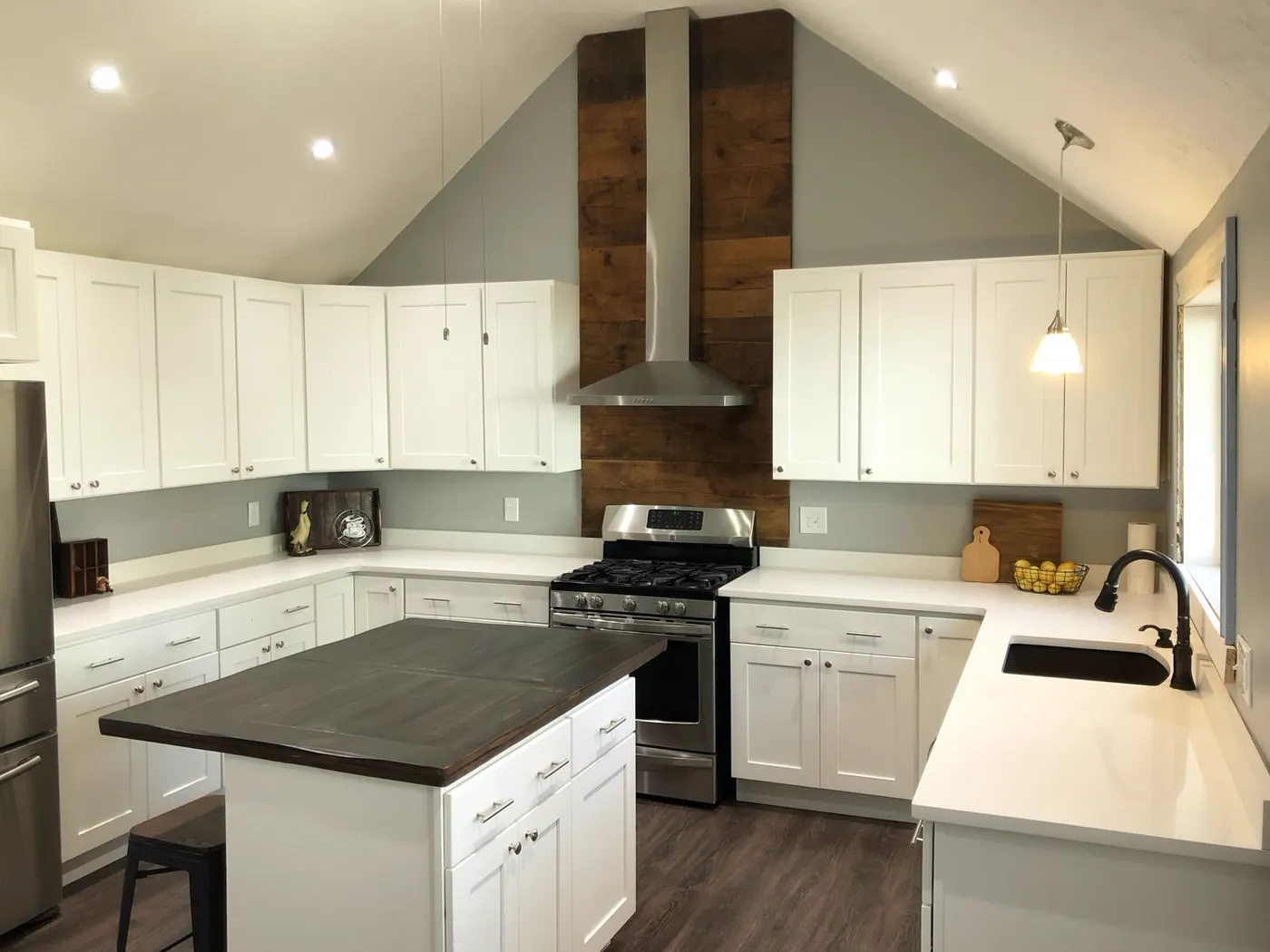 White kitchen with quartz worktops and a dark quartz island